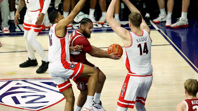 Feb 4, 2024; Tucson, Arizona, USA; Stanford Cardinal guard Jared Bynum (1) drives to the basket against Arizona Wildcats forward Keshad Johnson (16) and center Motiejus Krivas (14) during the first half at McKale Center. Mandatory Credit: Zachary BonDurant-USA TODAY Sports